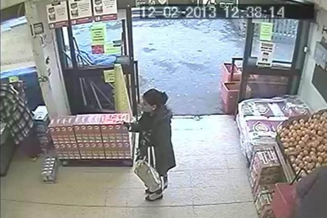 CCTV captures an unidentified accomplice snapping a picture of the misplaced juice box before Ashraf (left) turned and feigned tripping over it.