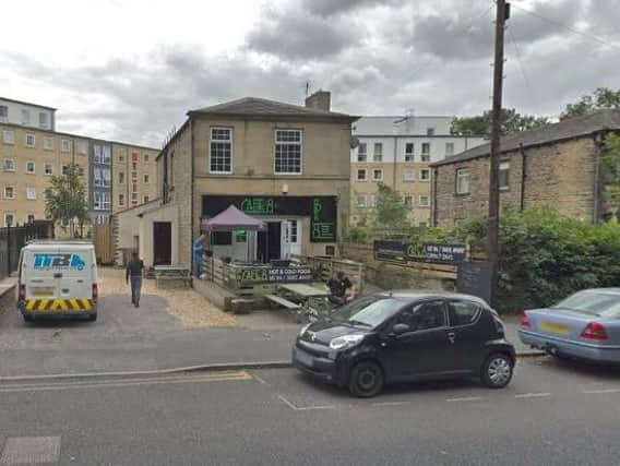 A woman was punched in a suspected domestic incident outside this caf in Huddersfield