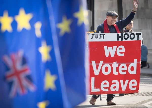 Leave and Remain supporters outside the Houses of Parliament.