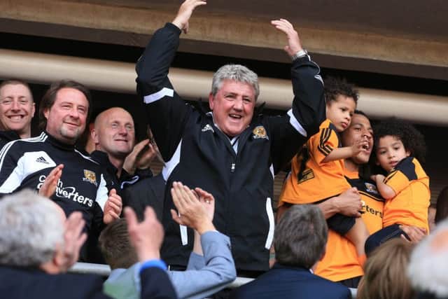 Hull City's manager Steve Bruce celebrates in the stands after his side clinched promotion in 2013 (Picture: PA)