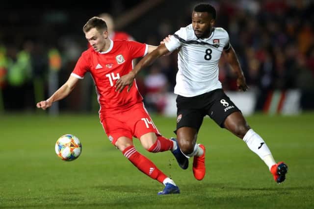 Wales' Ryan Hedges, left, duels with Trinidad and Tobago's 	Khaleem Hyland at the Racecourse Ground, Wrexham last month (Picture: Nick Potts/PA Wire).