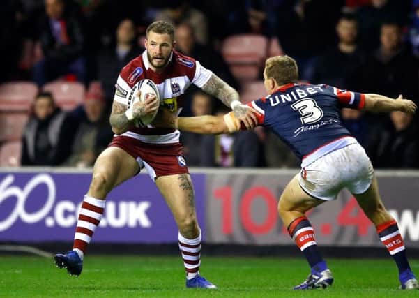 WELCOME BACK: Wigan's Zak Hardaker runs at Sydney Roosters' Mitchell Aubusson during the World Club Challenge match in February. Picture: Martin Rickett/PA