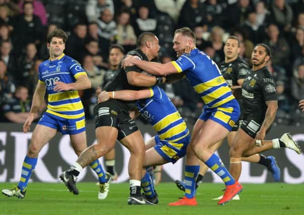 TOUGH NIGHT: Sika Manu is held up during last week's dismal defeat to Warrington Wolves.  Picture: Bruce Rollinson