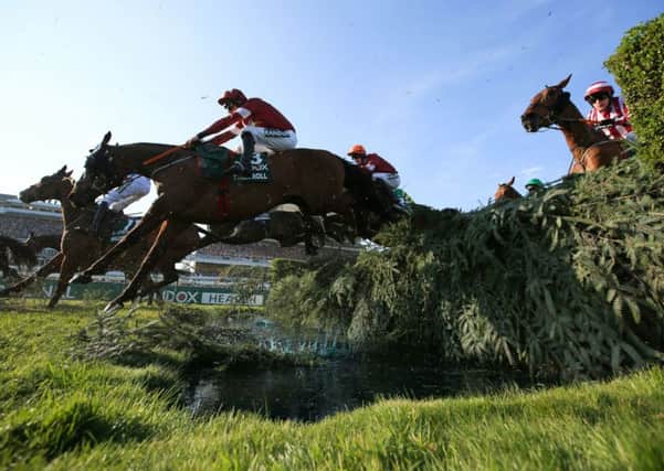 Davy Russell and Tiger Roll clear the water jump in the Grand National.