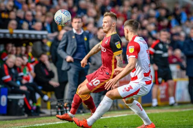 Close encounter: Bradford's David Ball shields the ball from Doncaster's Danny Andrew.