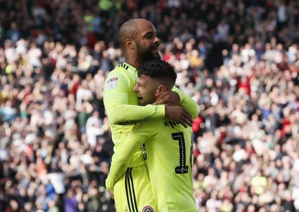 Match-winner: David McGoldrick is hugged by Oliver Norwood after scoring what proved the winning goal.