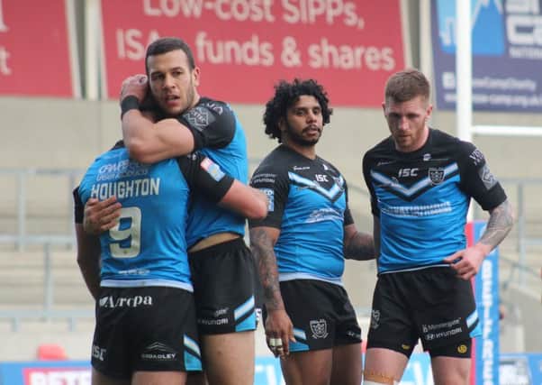 Carlos Tuimavave hugs Danny Houghton after Hull FC secured Super League victory over Salford Red Devil with Albert Kelly and Marc Sneyd, right, in attendance (Picture: Hull FC).