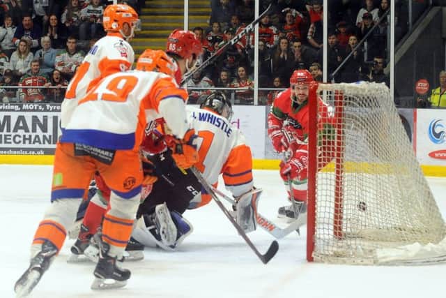 Joey Martin pokes the puck home past Jackson Whistle. Picture: EIHL/Devils