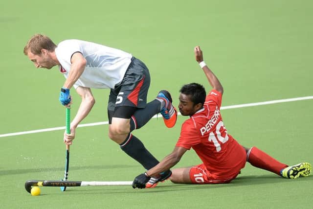 England's Barry Middleton battles for the ball with Canada's Keegan Pereira during the 2014 Commonwealth Games in Glasgow. (Picture: Martin Rickett/PA Wire)