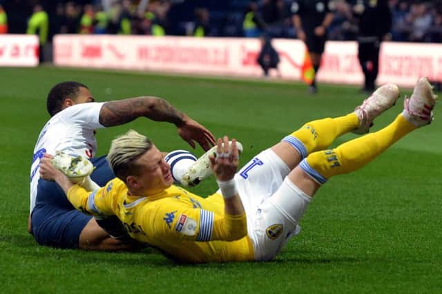 Ezgjan Alioski falls to the ground after colliding with Preston's Lukas Nmecha.

Picture: Bruce Rollinson