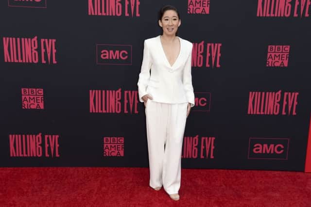 Killing evening dressing - How to wear white for night -  Sandra Oh steps out for the season two premiere of Killing Eve in Los Angeles serene and elegant in a simple white trouser suit worn unadorned. (Photo by Richard Shotwell/Invision/AP)