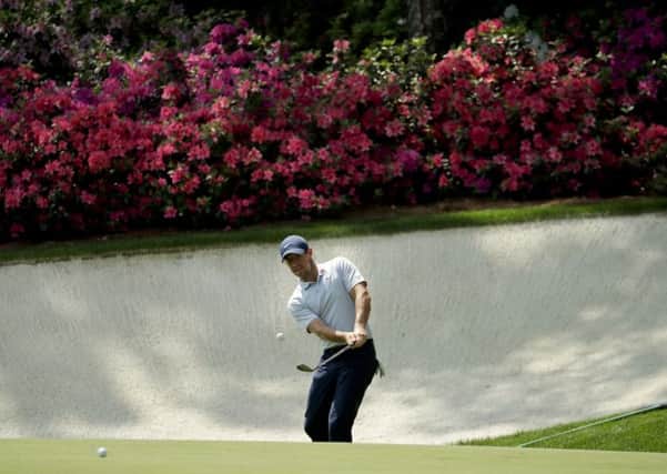 Ready for action: Rory McIlroy hits out of the bunker on the 13th hole during a practice round.