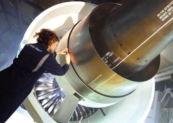 A worker inspects a Trent 1000 Aircraft engine at one of the Rolls Royce plants.