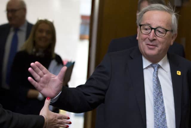 European Commission President Jean-Claude Juncker prepares to shake hands as he arrives for a meeting of the College of Commissioners at EU headquarters in Brussels this week (AP Photo/Virginia Mayo)