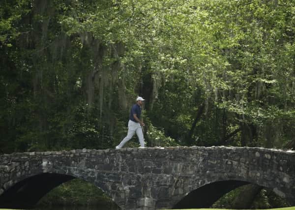 Crossing the bridge to success?: Tiger Woods goes over the Nelson Bridge on the 13th hole.