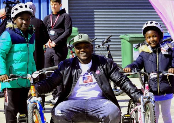 Waleed Bashir with his children Waghe 10 (left) and Wjhen Bashir with their new bicycles at R-evoution in Cottingham near Hull part of a new scheme for refugees to get bicycles..