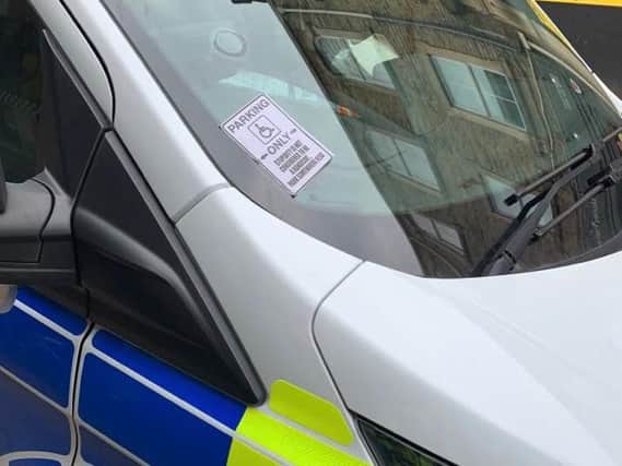 A 'do not park here' sign was stuck onto a parked police car as officers were attending a burglary. Photo: West Yorkshire Police