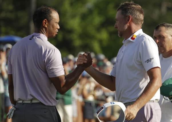 Well done: Tiger Woods shakes hands with Ian Poulter on the 18th hole.