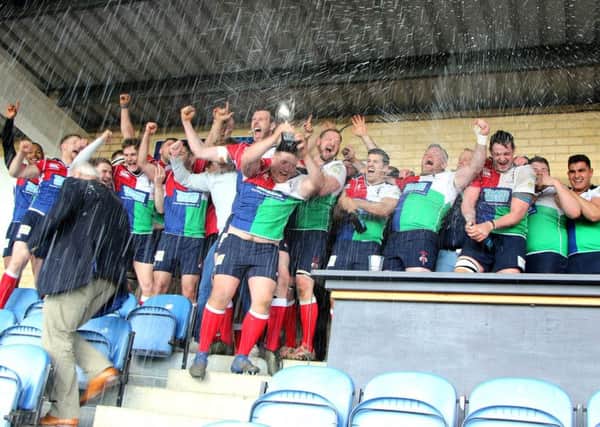 Champagne moment: Hull Ionians players and staff celebrate their promotion to National One. (Picture: Malcolm Moorhouse)
