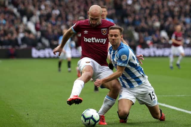 West Ham United's Pablo Zabaleta (left) and Huddersfield Town's Chris Lowe (right) battle for the ball during the Premier League match at London Stadium. (Picture: John Walton/PA Wire)