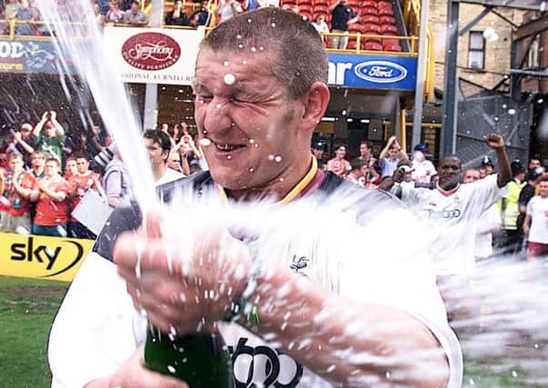 Survival: Bradford City's Dean Windass celebrates with Champagne after his side avoided relegation by beating Liverpool in 2000 after a successful Easter.