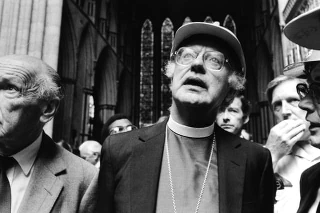 A shocked Archbishop of Canterbury, Dr Robert Runcie, inspects the damage following the fire in July, 1984. (YPN).