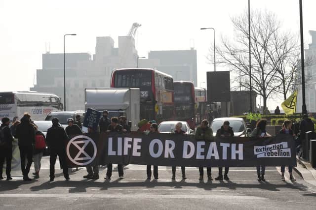 Extinction Rebellion protesters hold up buses in London.