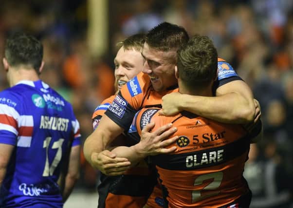Castleford's Greg Minikin celebrates his try with Cory Aston and James Clare. Picture Jonathan Gawthorpe