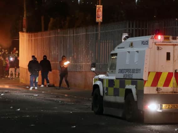 Petrol bombs are thrown at police in Creggan, Londonderry.