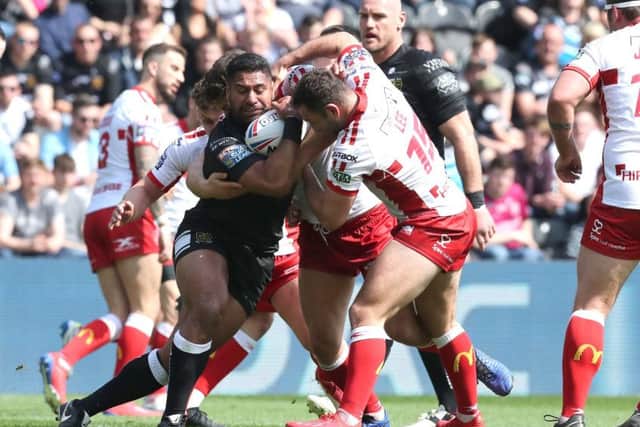 Mickey Paea is tackled by the Hull KR defence.