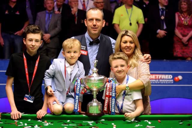 Mark Williams and family with the trophy after winning the 2018 Betfred World Championship at The Crucible. Picture: Richard Sellers/PA