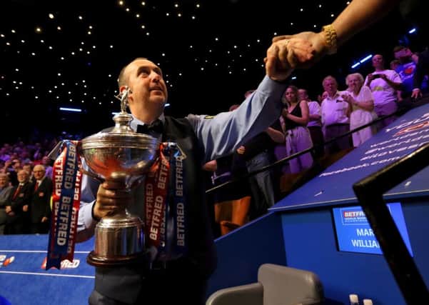 Mark Williams with the trophy after winning the 2018 Betfred World Championship.
