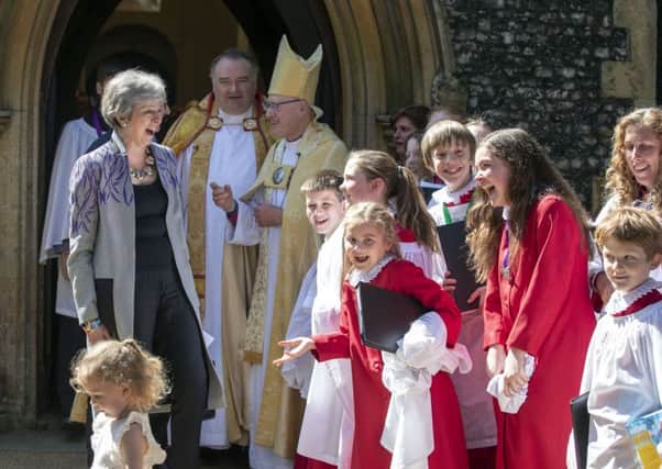 Prime Minister Theresa May speaks with choristers as she leaves an Easter Sunday church service near her Maidenhead constituency. The Prime Minister has been accused of squandering taxpayers' money.