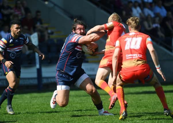 TOUGH TIMES: Doncaster's Rory Pitman is tackled by Coventry's Pete White.
 Picture: Jonathan Gawthorpe