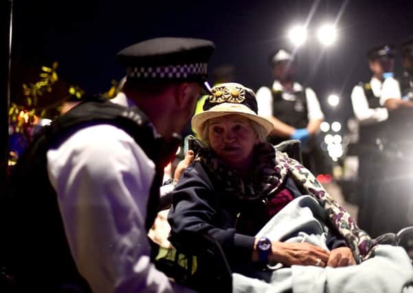 Police remove Extinction Rebellion demonstrators from Waterloo Bridge in London.
