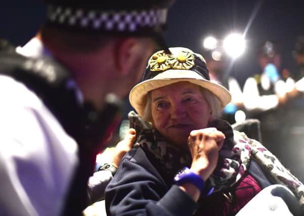 Police remove Extinction Rebellion demonstrators from Waterloo Bridge in London.
