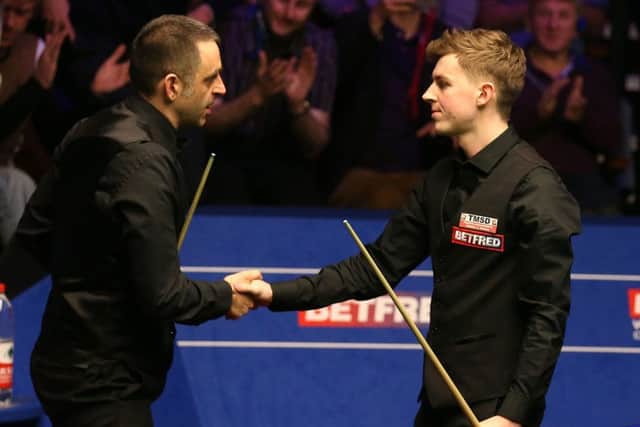 James Cahill (right) is congratulated by Ronnie O'Sullivan at The Crucible. Picture: Nigel French/PA