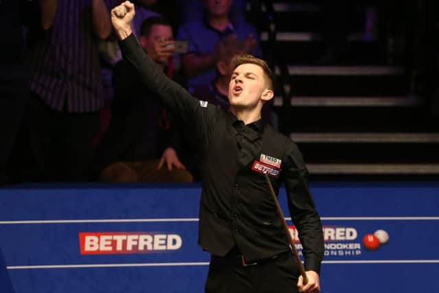 James Cahill celebrates after beating Ronnie O'Sullivan 10-8.