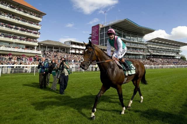 Crowds salute Frankel after the horse's Juddmonte International win.