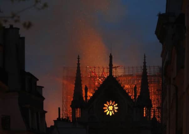 Flames and smoke rise from Notre Dame cathedral as it burns. Photo/Thibault Camus