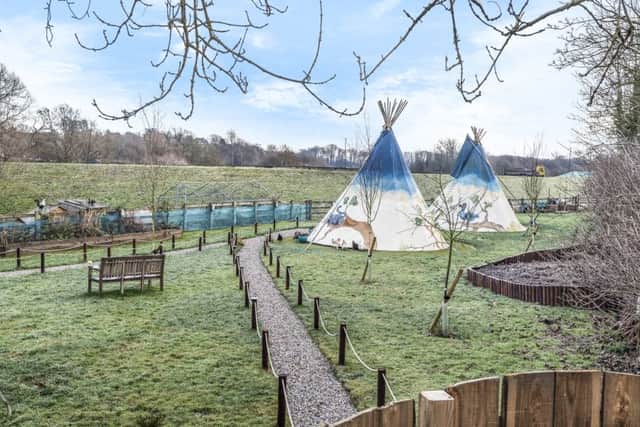 The tipis on the riverside site
