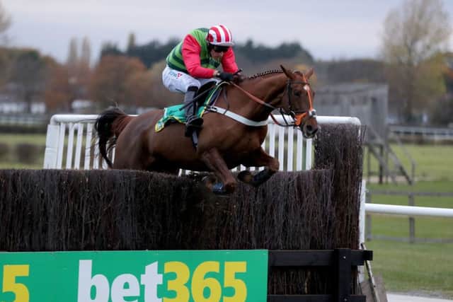 Danny Cook and Definitly Red clear the last before winning Wetherby's Charlie Hall Chase.