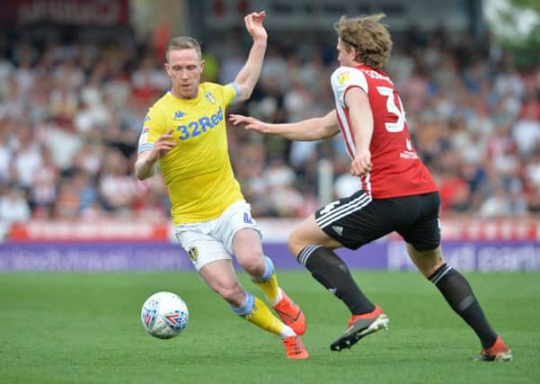 Adam Forshaw duels with Brentford's Mads Bech Sorenson during Monday's loss for Leeds United (Picture: Bruce Rollinson).