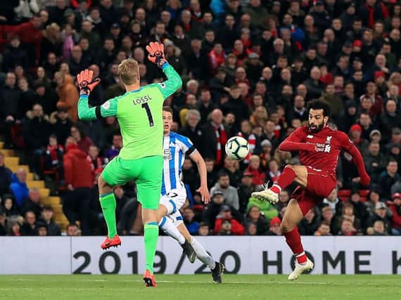Liverpool's Mohamed Salah scores his side's third goal against Huddersfield Town. Picture: Peter Byrne/PA