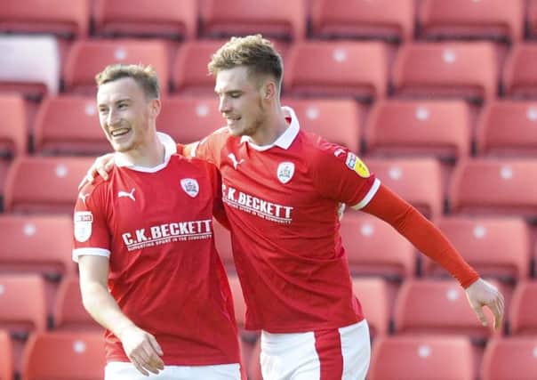 Match-winner: Barnsley's Liam Lindsey is congratulated by Mike Bahre after scoring the winner at Oakwell.