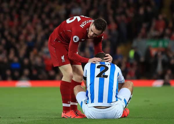 Chin up: Liverpool's Andrew Robertson consoles Huddersfield Town's Tommy Smith.