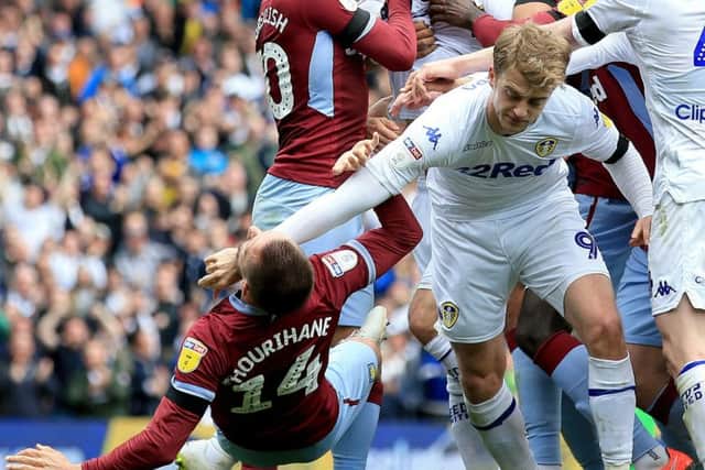 Leeds United's Patrick Bamford manhandles Aston Villa's Conor Hourihan during the 1-1 draw between the sides.