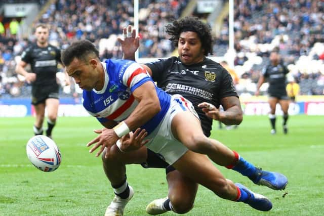 Wakefield's Mason Caton-Brown tries to get across the line under close attention from Hull FC's Albert Kelly. (SWPix)