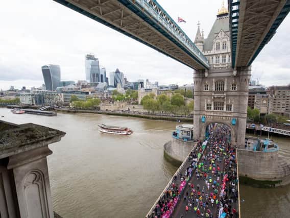 More than 1bn has now been raised by runners taking part in the London Marathon since it was first held in 1981. Here, runners are pictured crossing Tower Bridge. Picture by Aaron Chown/PA Wire.