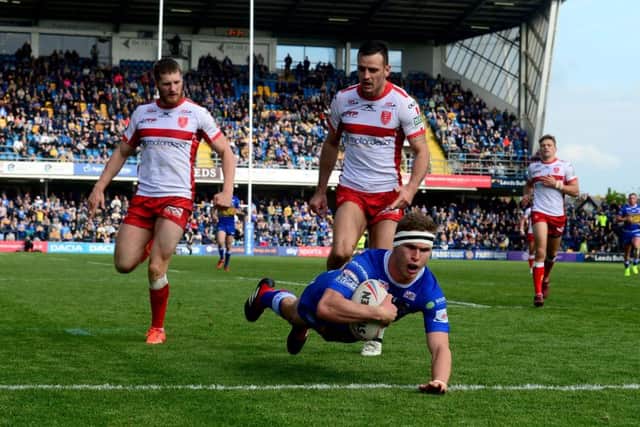 Matt Parcell, of Leeds Rhinos, dives to the ground to score a try.
